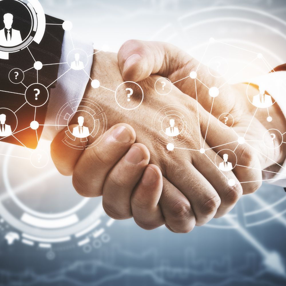 Two hands shaking with digital network elements overlay on a blurred background